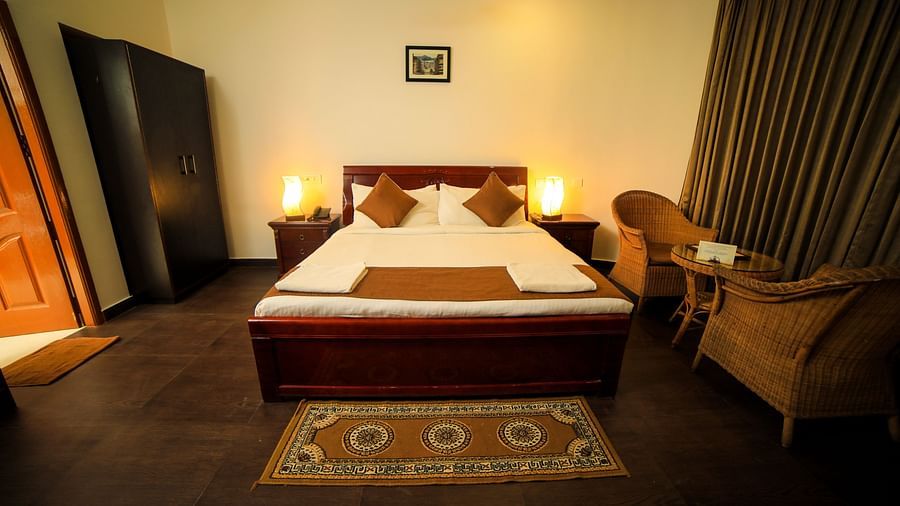 Image of a room with a bed and a wardrobe on the side at WOW Bison Woods.