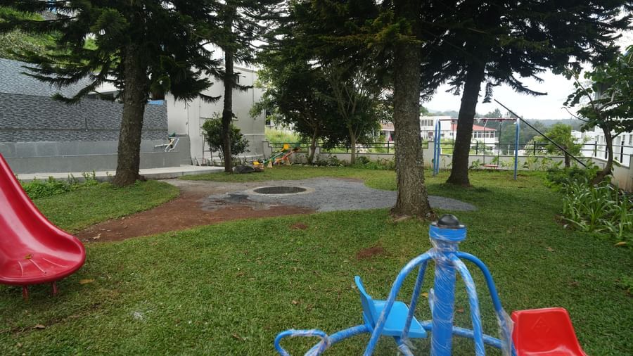 Full-view shot of the outdoor childern's play area along with the bonfire pit at the WOW Naturefull Resorts.