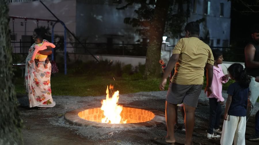 A wide-angle shot featuring the bonfire at WOW Naturefull Resorts with families loitering around it.