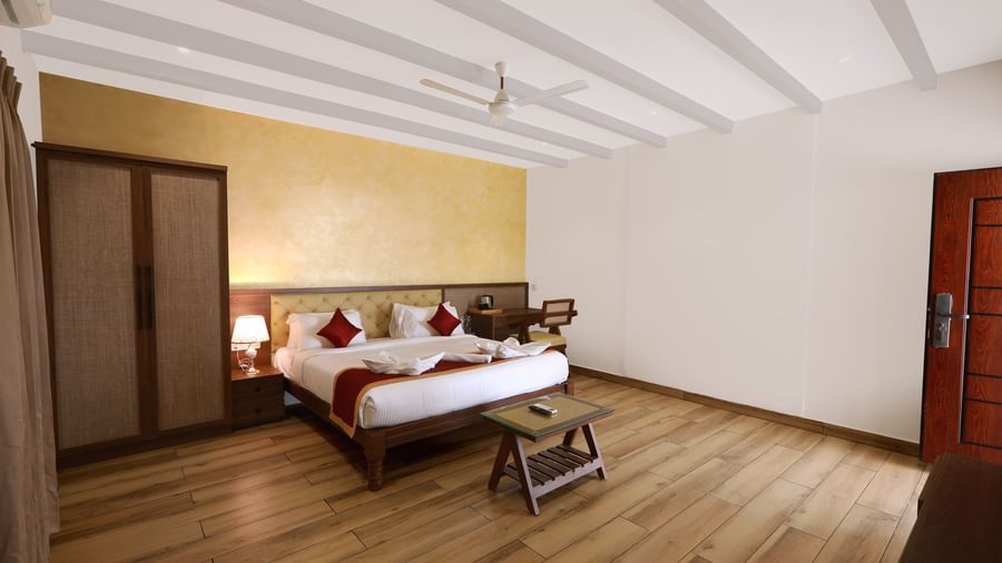 Full view of an expansive bedroom featuring a double bed along with a wardrobe in the Terrace Cottage at WOW Naturefull Resorts, Yercaud.
