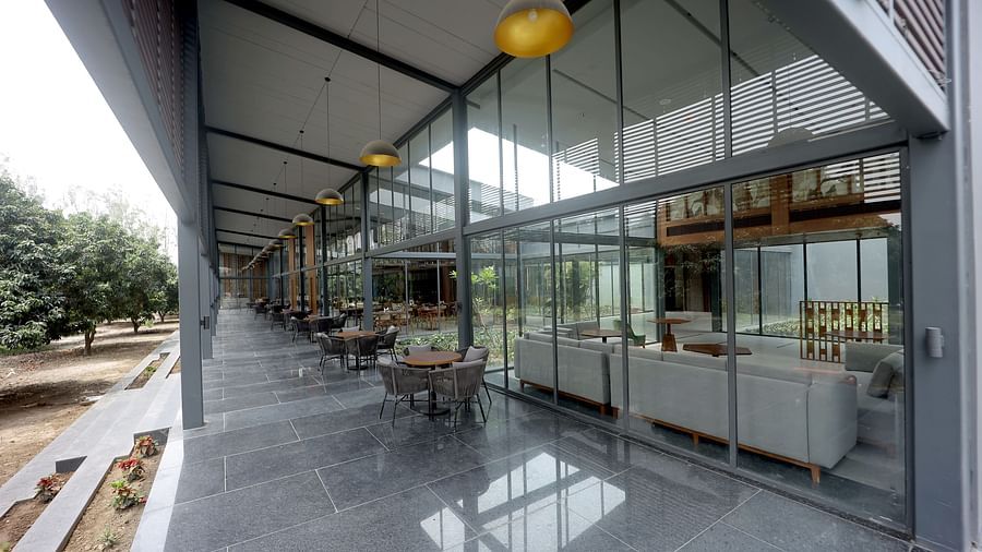 Spacious glass corridor with polished floors and natural light flowing through high windows at Wyndham Garden.