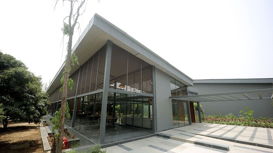 Exterior view of the Wyndham Garden building with slanted roof and landscaped surroundings.