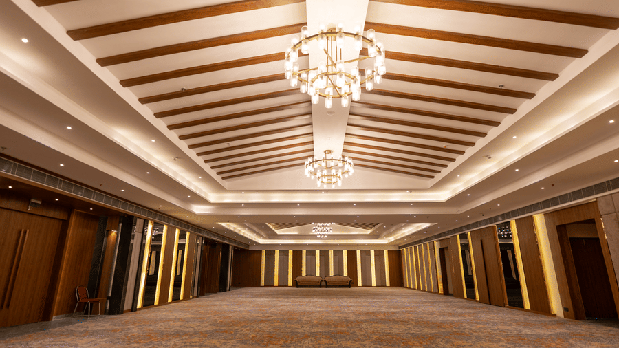 A large banquet hall at Wyndham Garden showcasing a detailed ceiling pattern and an ample event area.