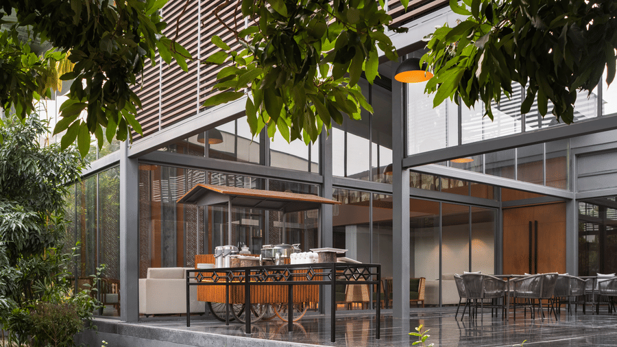 Modern open-air dining pavilion surrounded by greenery at Wyndham Garden.