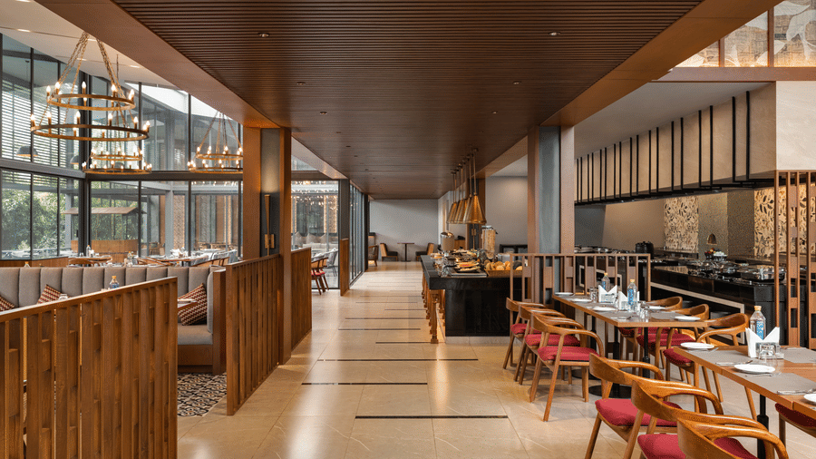 Stylish indoor restaurant with wooden ceiling and vibrant seating at Wyndham Garden.