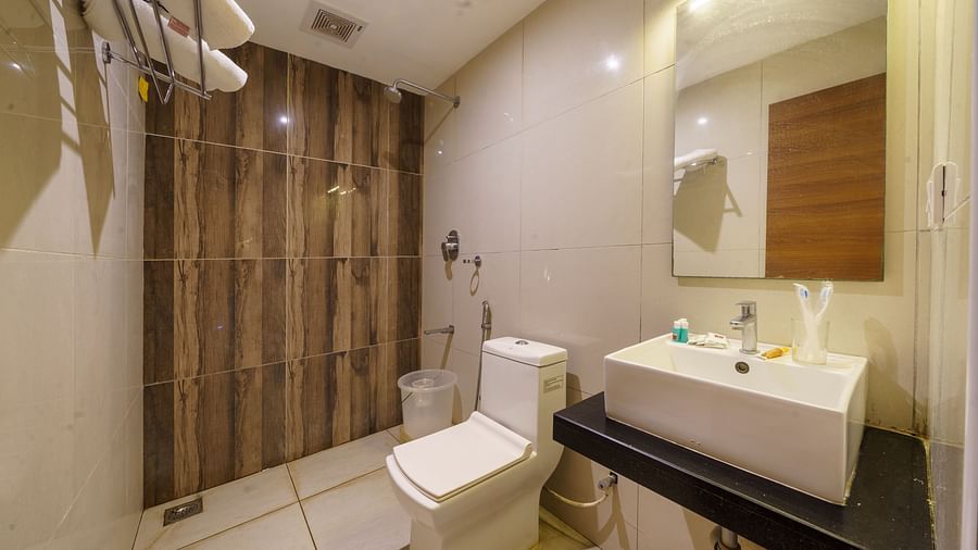 Bathroom with wash basin and shower corner at Wyt Hotels, Rameswaram
