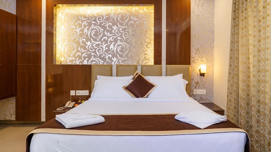 Deluxe room with bed and pillows at Wyt Hotels, Rameswaram