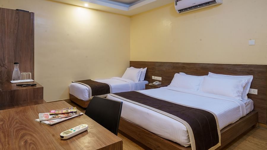 Room with two spacious bed and table at Wyt Hotels, Rameswaram 