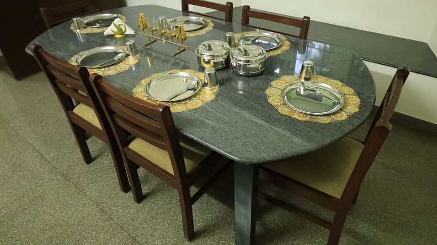 Shot of a dining table with plates, silverware, and placemats.