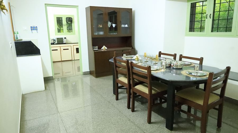 Image of the dining room with a table, chairs, and a cabinet.
