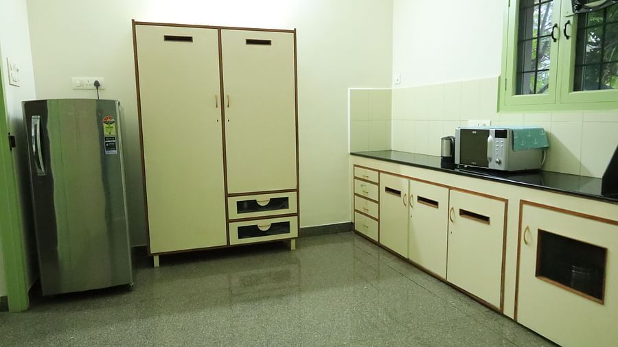 Image of a  clean and tidy kitchen with white cabinets and appliances.