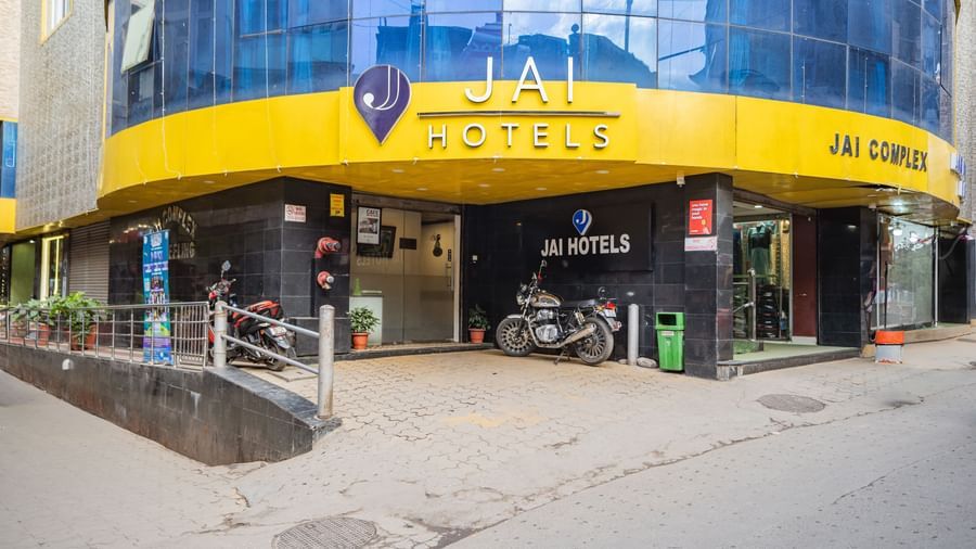 The bright yellow exterior and main entrance of the Yashshree Jai Hotel & Banquet, Darjeeling.