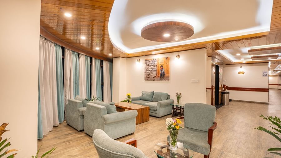 A stylish hotel lobby and waiting area with comfortable sofas at the Yashshree Jai Hotel & Banquet, Darjeeling.
