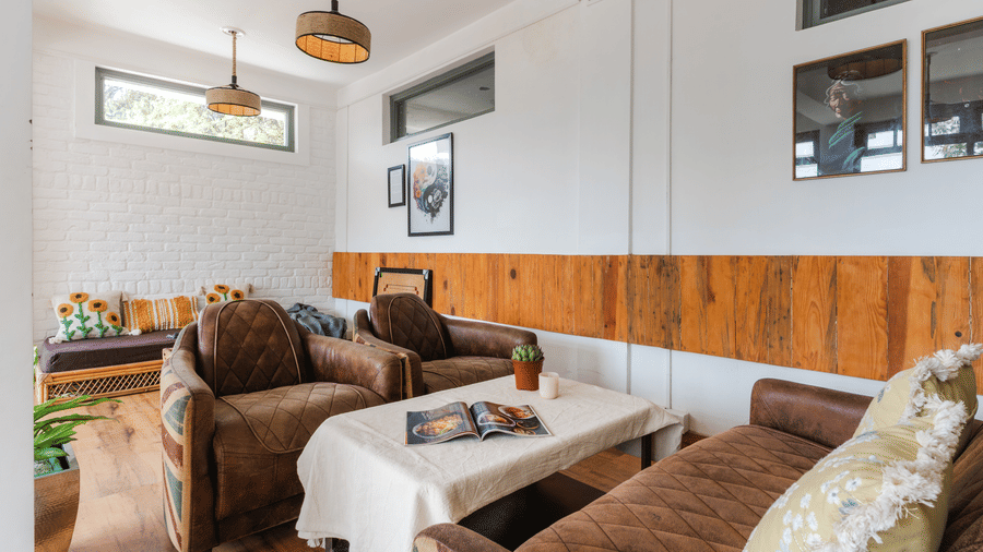 An indoor living area with a sofa and armchairs at Ziran Retreat.