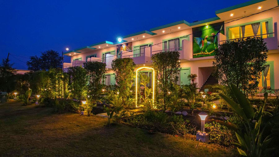 Night view of walkway and entry arch with warmly lit building facade at The Mallard Corbett
