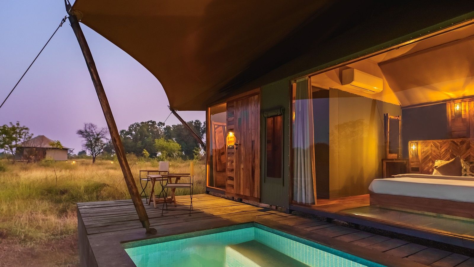 A view from outside of a tent with a plunge pool at Trees N Tigers, Tadoba.