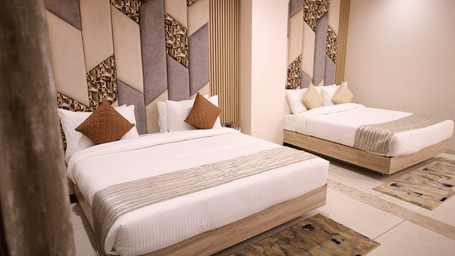 2 comfortable double beds are neatly prepared in a stylishly decorated room - Lords Inn Sangam, Bhopal