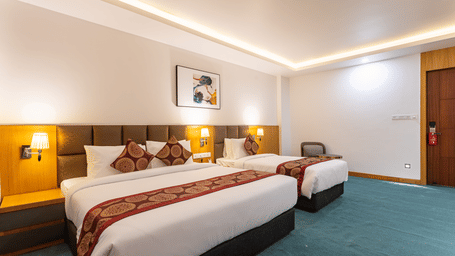 Two double beds with lamps on either side
