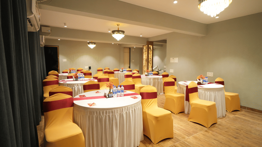 A class room style seating arrangement with chandelier lights