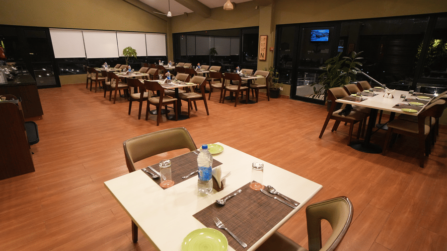 Restaurant seating area with neatly arranged chairs and tables