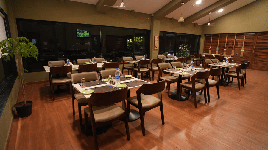 A dimly lit restaurant seating arrangement with wooden floors