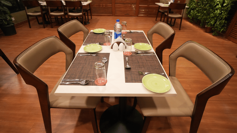 A table for four, plates, water, glasses and napkin set for diners