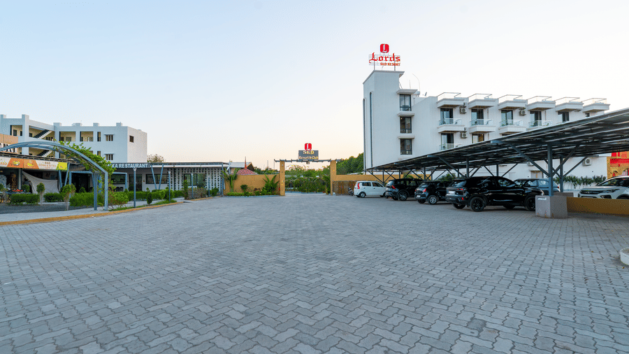Exterior view of Lords SKD Resort, Salangpur with spacious driveway and main building entrance.