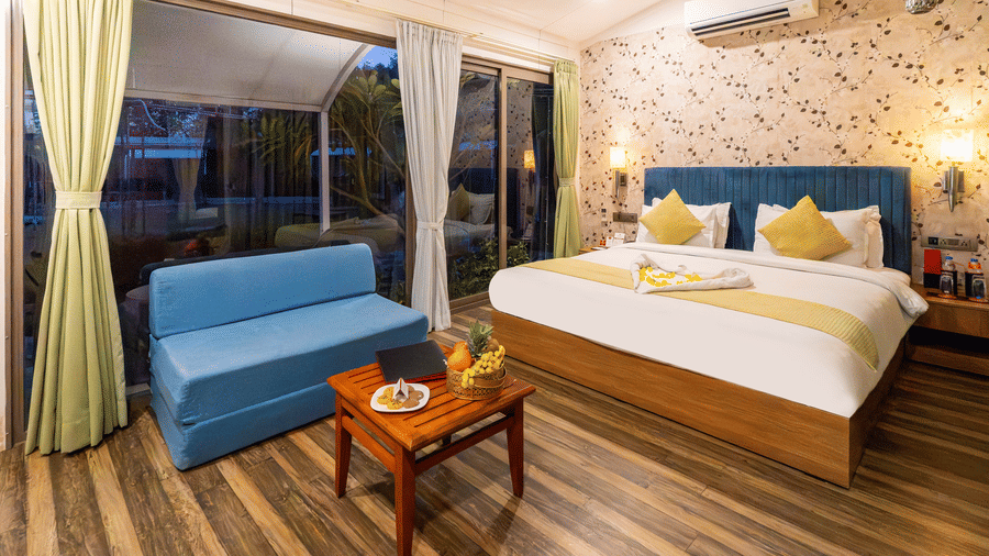 Stylish bedroom with king size bed, sofa, and warm lighting at Lords SKD Resort, Salangpur.