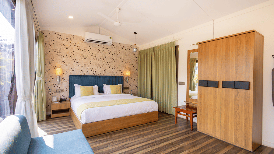 Elegant bedroom with king size bed and contemporary décor at Lords SKD Resort, Salangpur.