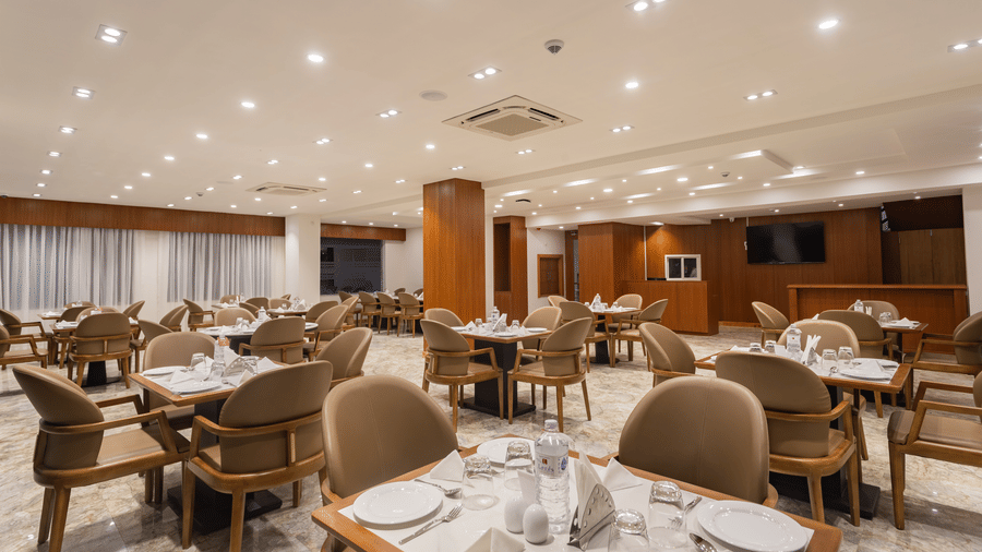 Close view of The Blue Coriander restaurant at Mandala Norling Lords Prime in Kathmandu featuring a fine dining seating arrangement and well-placed cutlery.