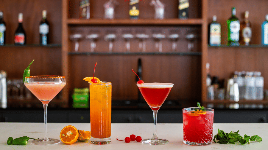 Four vibrant looking drinks with decoratives placed on a counter-top at Mandala Norling Lords Prime in Kathmandu.