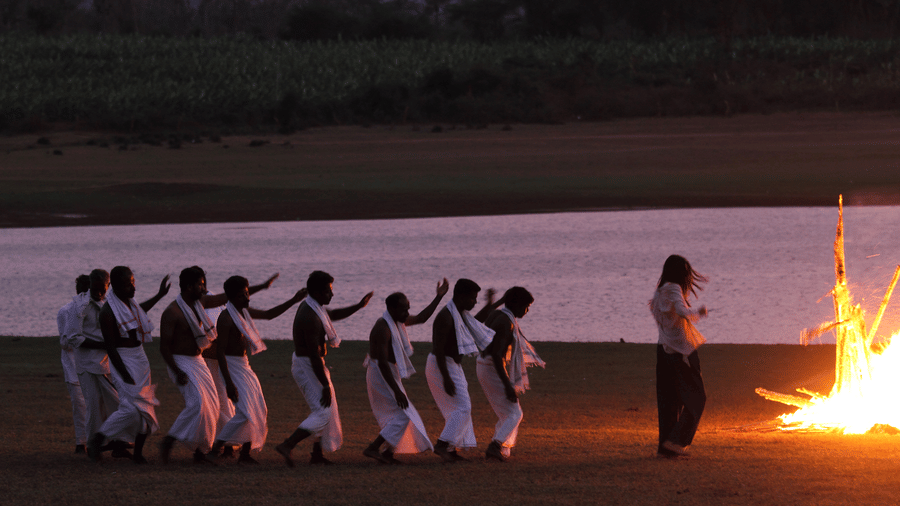 Tribal fire dance performance on the riverbank near Evolve Back Kabini
