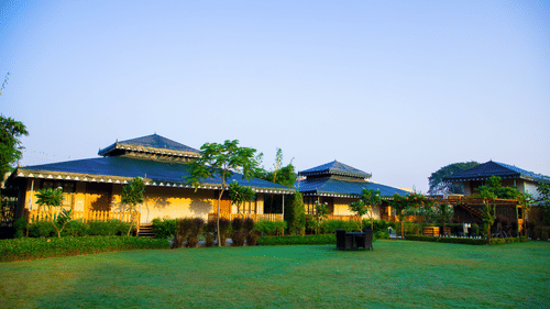 A facade view of The Baagh Ananta Elite, Ranthambore with a lawn in the foreground - Resort Near Ranthambore