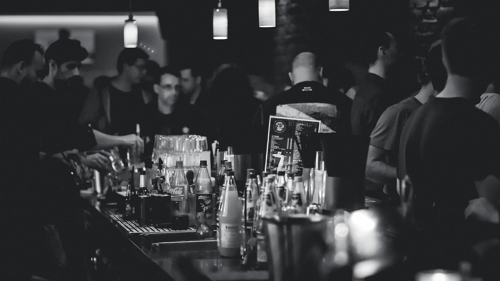 a bar counter with alcohol in bottles