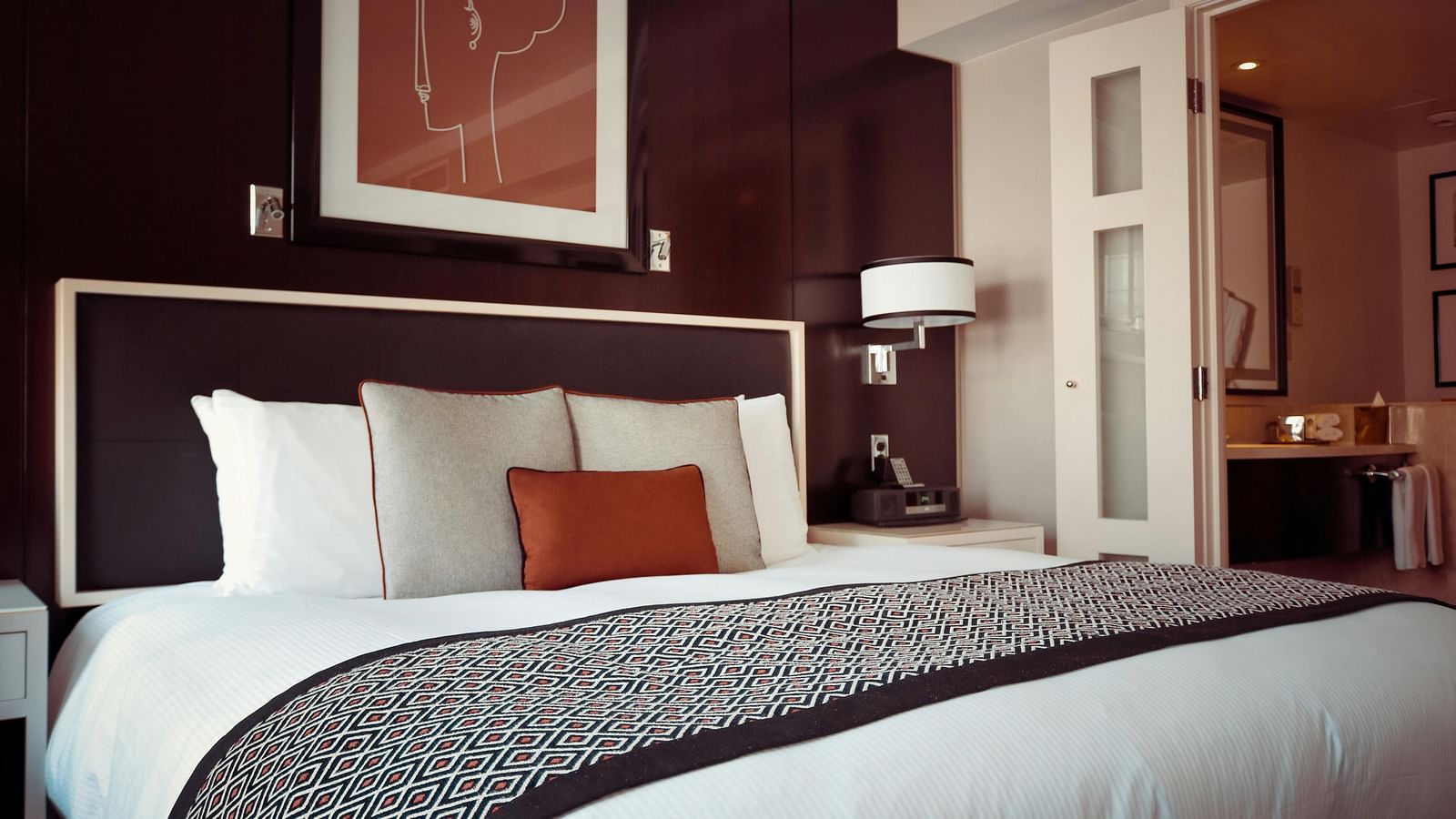 A close view of double bed with some pillows and frame on the above