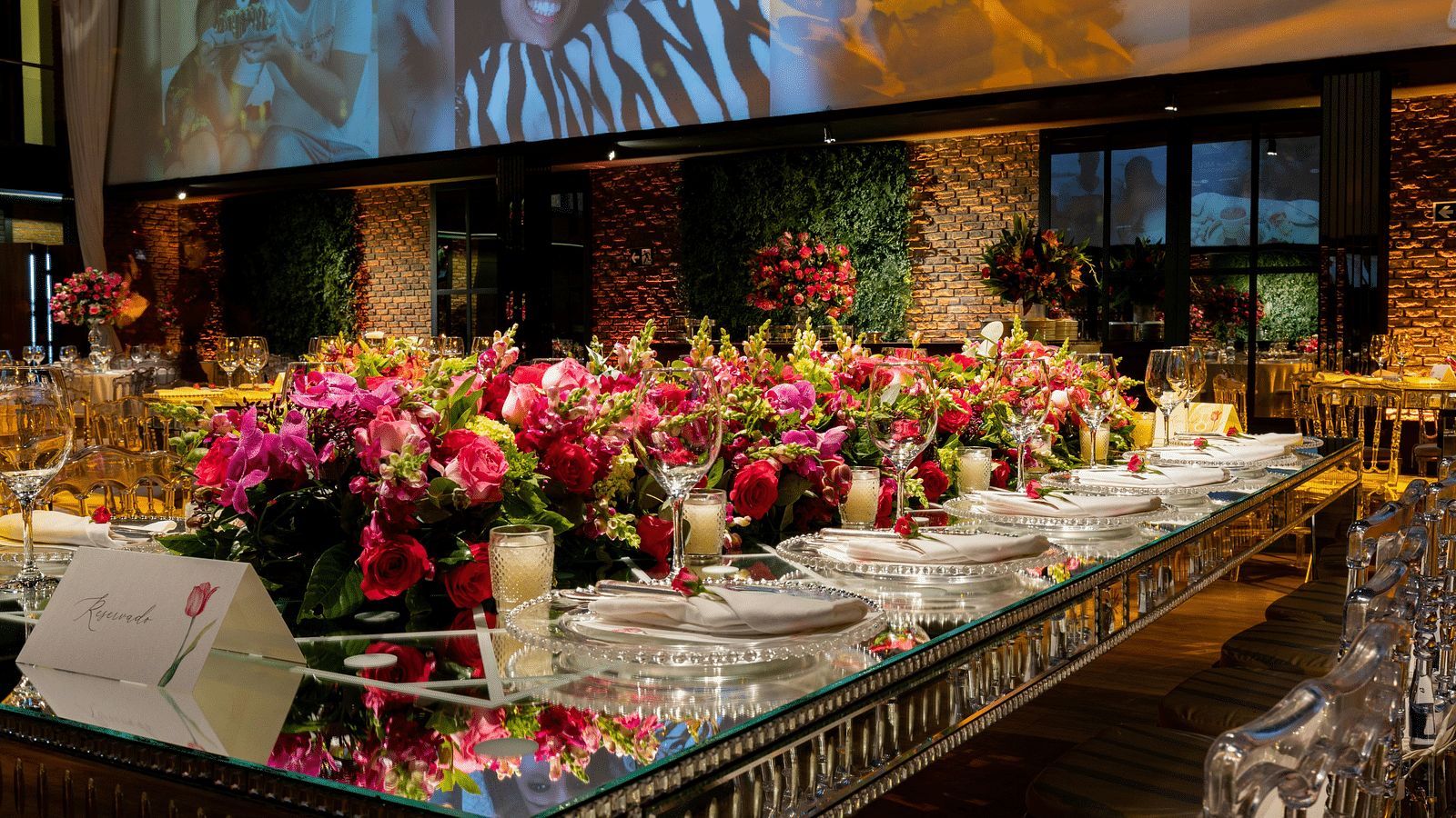 The banquet hall, adorned with flowers, is prepared for the celebration.