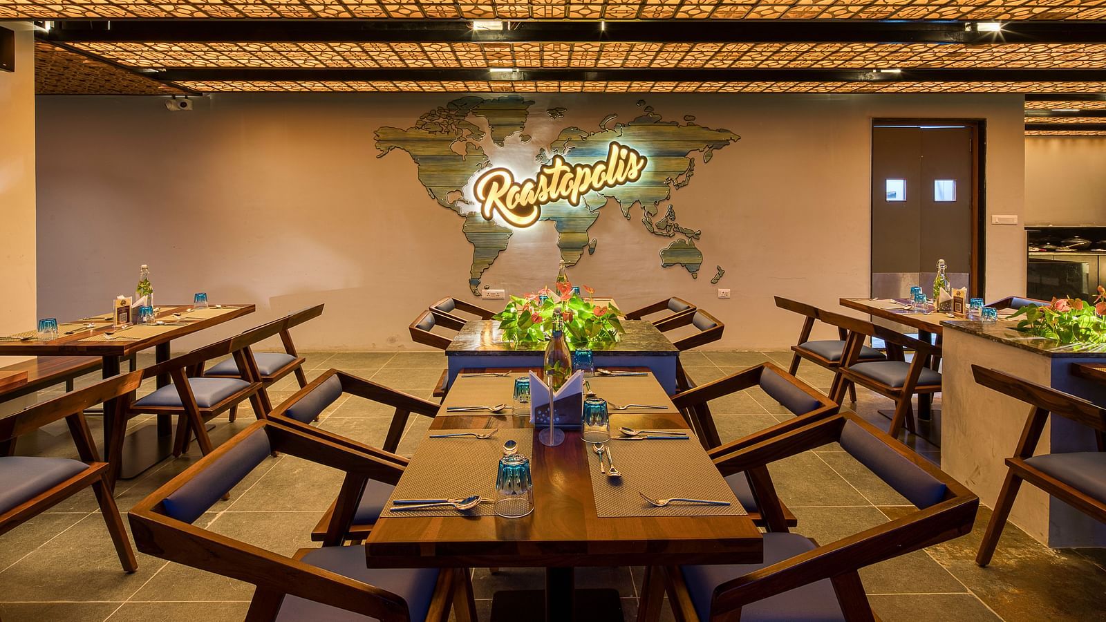 Interior of Roastopolis Restaurant at Le Foliage by TGI, Bangalore where tables and chairs are well aligned