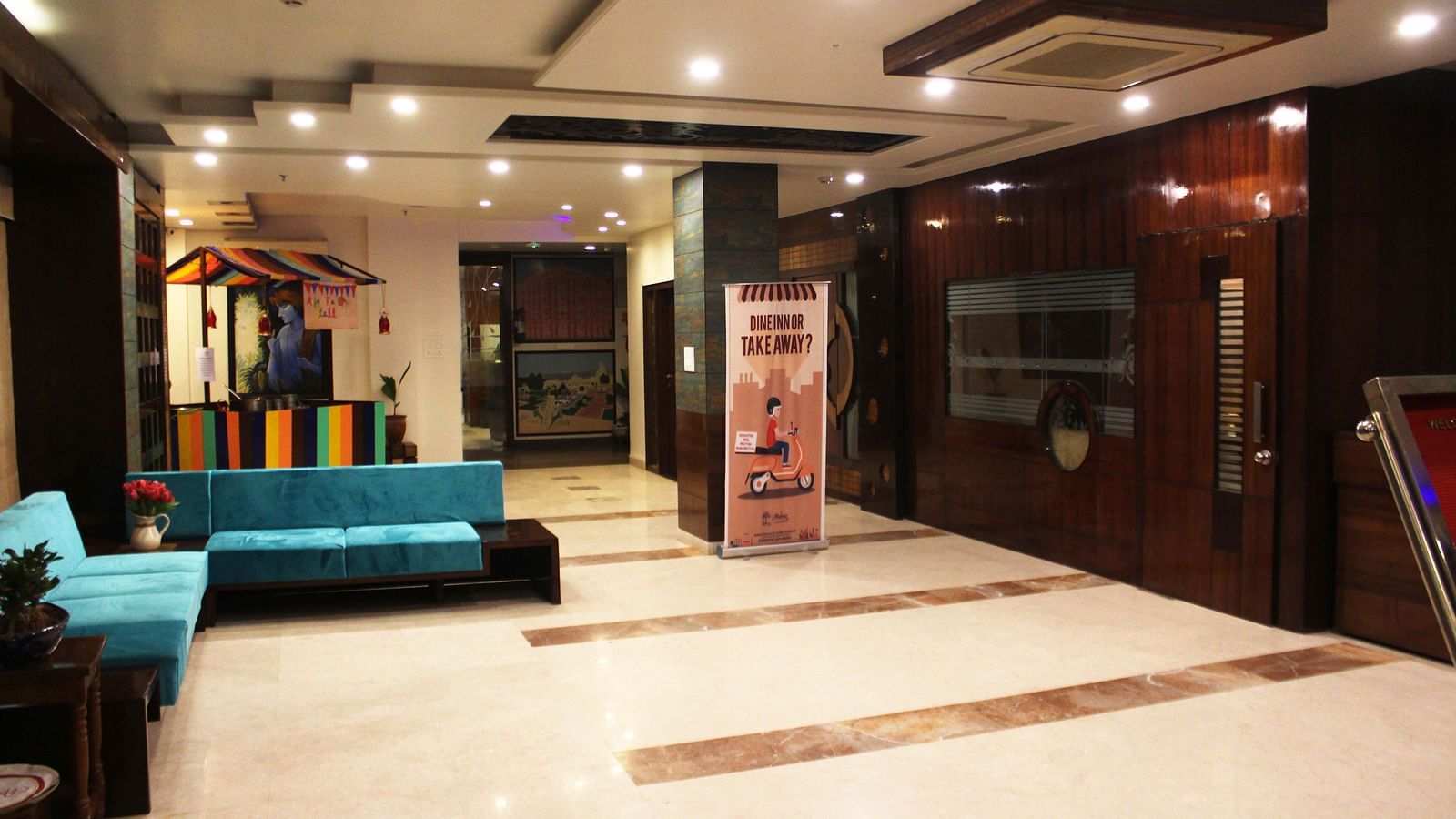 A well lit waiting hall of the hall with comfortable sofas for the guests waiting in the lobby - TGI Apple Inn, Jaipur 