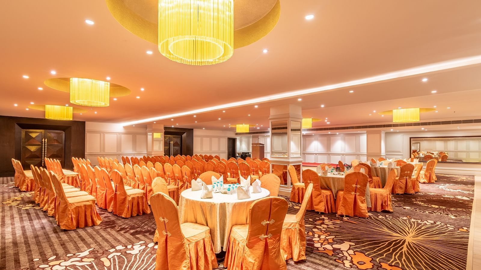 Banquet hall with round tables dressed in satin covers, perfect for a celebratory gathering