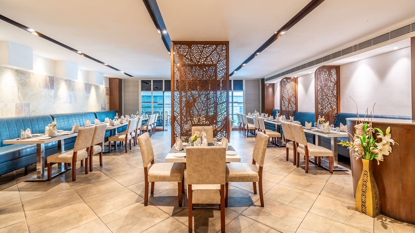 Stylish hotel restaurant with wooden interiors and well-spaced dining tables