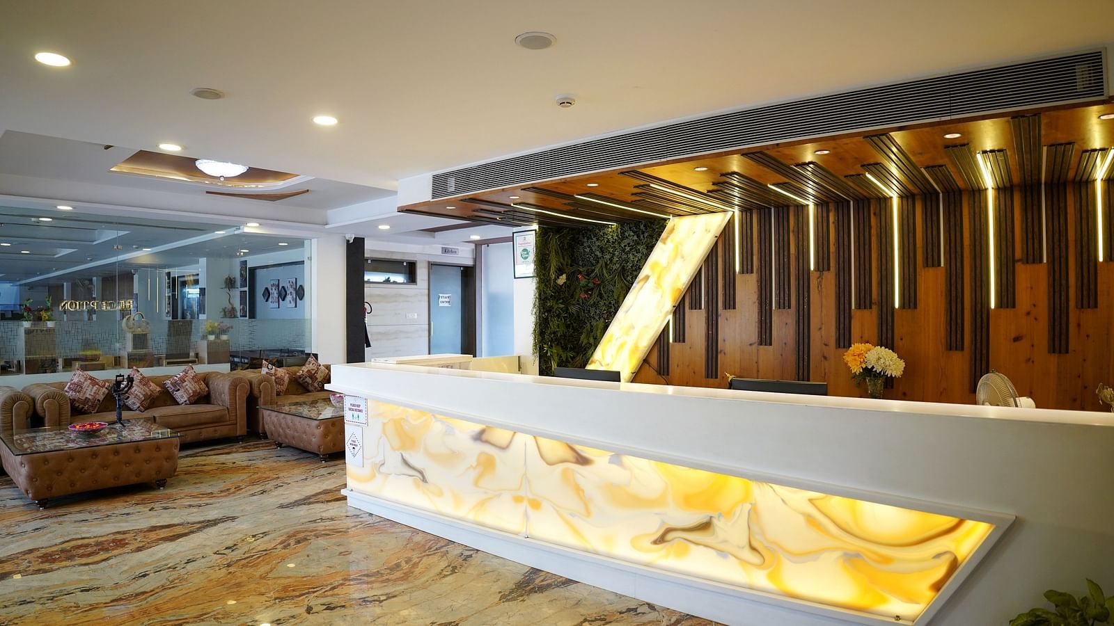 A spacious hotel lobby with modern decor and a reception desk - TGI Insignia, Bhopal