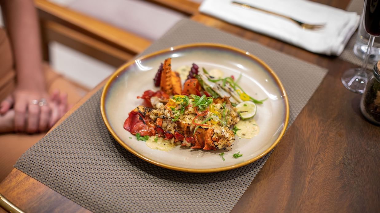 image of a well plated dish with a local coastal delicacy prepared at the beacon by the bay villas and suites