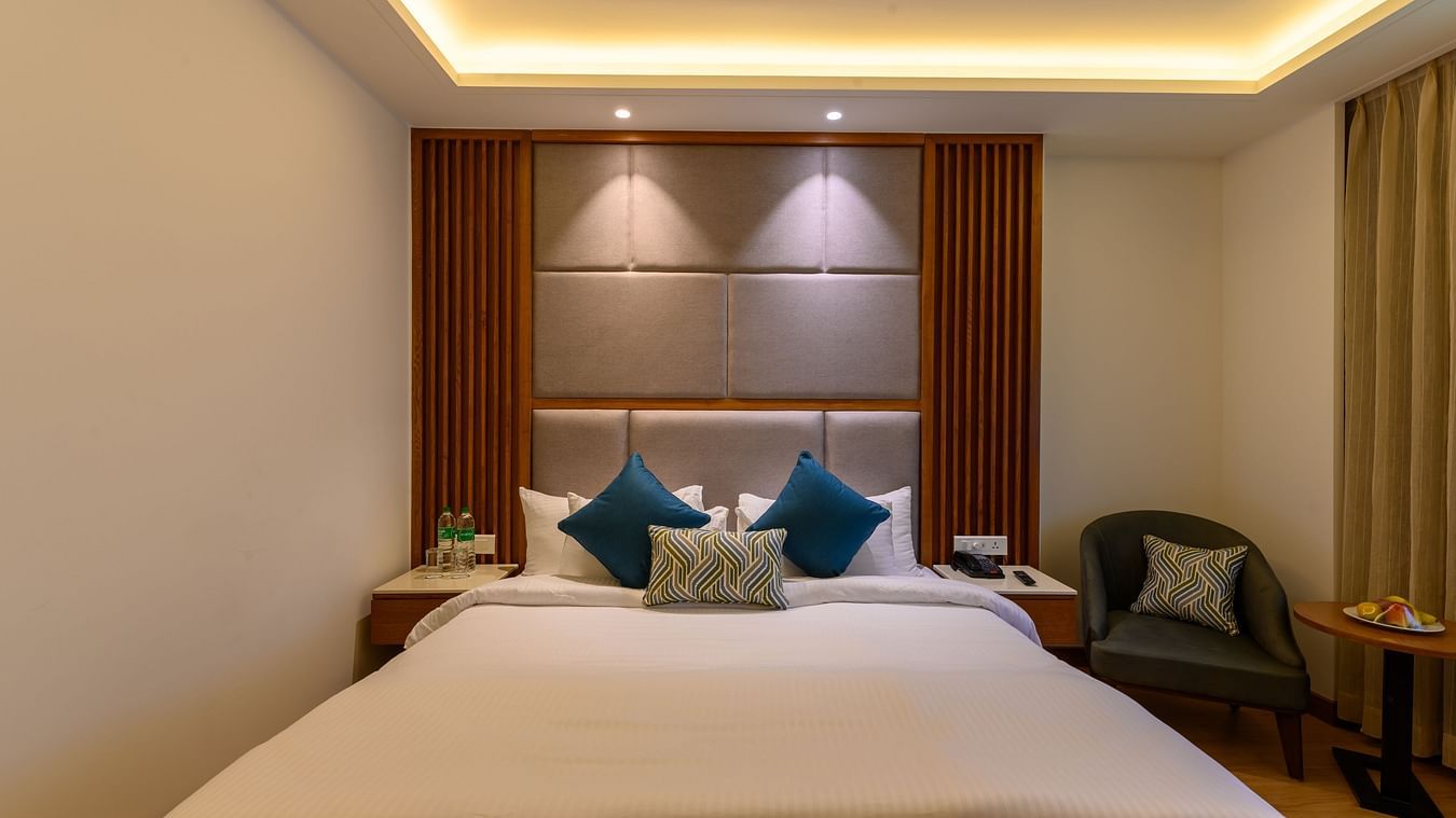 The interiors of the Classic Rooms in Pushkar featuring a bed, a sofa chair and exquisite furnishings at our resort 135
