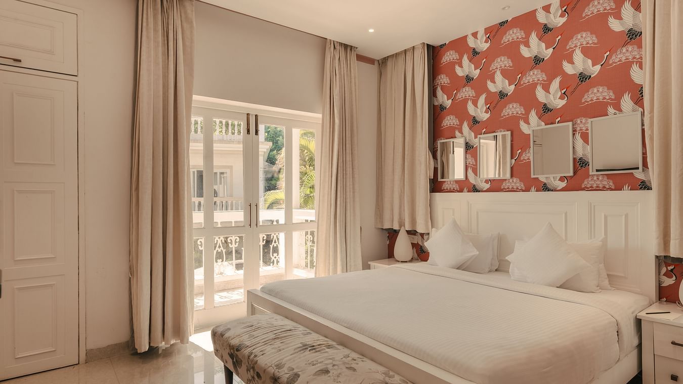 Spacious and well-lit bedroom with a balcony at Three BHK Premium Villa, Richmonde Ananta Elite, Goa.