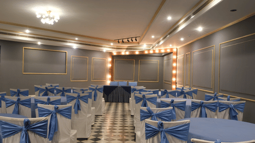 The beautifully appointed Party Hall with decorative lighting, elegant chair decor, and a cosy setting ideal for engagement ceremonies, cocktail evenings, and private celebrations | Clarks Amer, Jaipur