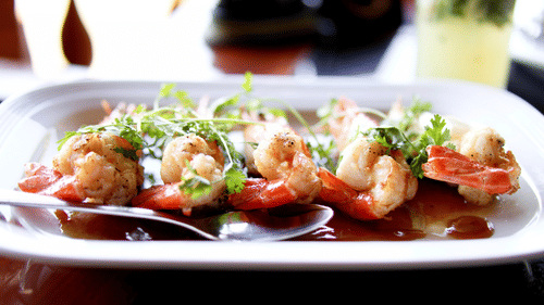 A plate of seafood placed on a surface at Heritage Village Resort & Spa, Goa.