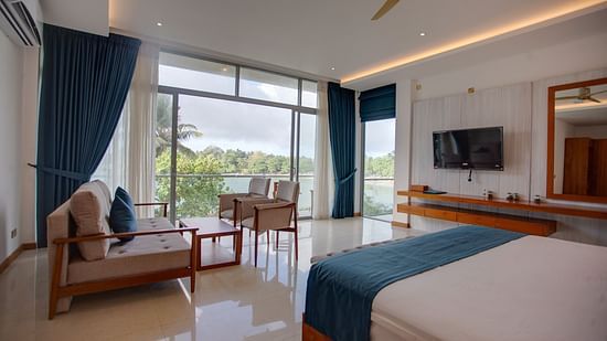 full view image of the sea view suite highlighting a bright open balcony 
