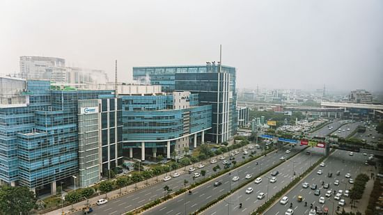 A panoramic view of a modern business district with multi-story buildings and a busy road