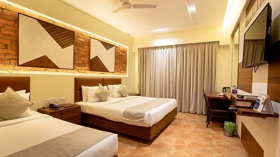 Picture showing the King size bed and the Single bed in the Super Deluxe Triple Suite at ZARA’s Resort - the best resort in Khandala for family