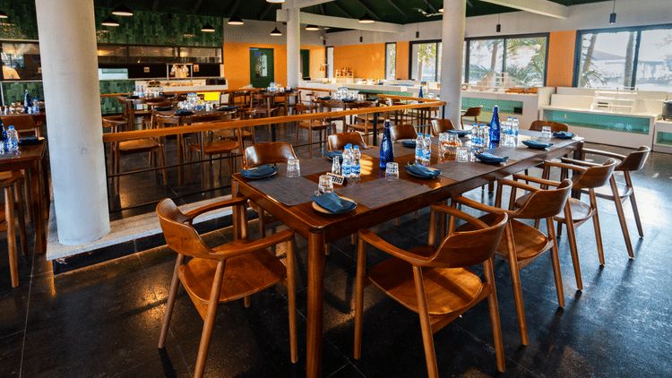 Song of the Sea at MGM Beach Resorts – elegant dining hall with high ceilings, pendant lights, and with wooden furniture